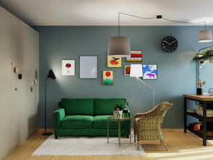 Mały pokój dzienny z zieloną sofą ratanowym fotelem kolorowa ściana i duża szafa z kolorowymi uchwytami