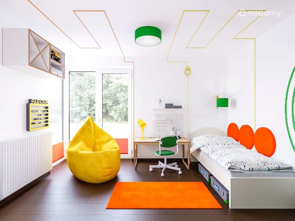 Pokój chłopca z zielonymi i żółtymi dodatkami i pomarańczowym dywanem