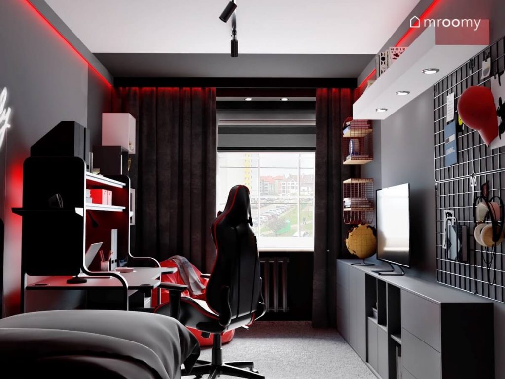 Monochromatyczny pokój dla nastolatka z czarnymi i szarymi meblami oraz czerwonymi akcentami