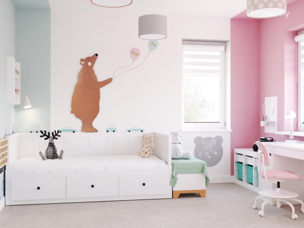 Białe łóżko z szufladami w pokoju dziewczynki i chłopca a na ścianie sklejkowy niedźwiedź z balonami