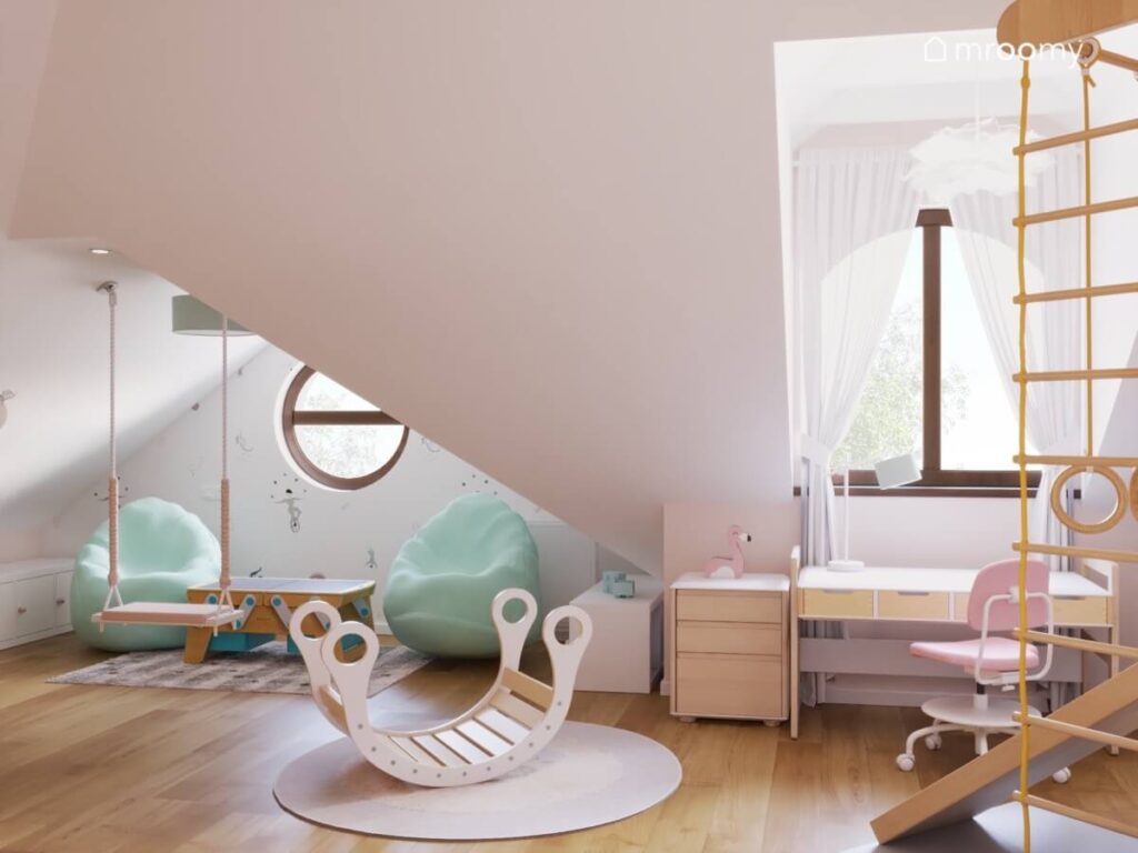 Bujak na dywanie z motylem dwie miętowe pufy huśtawka oraz biurko z różowym krzesłem w poddaszowym pokoju małej dziewczynki